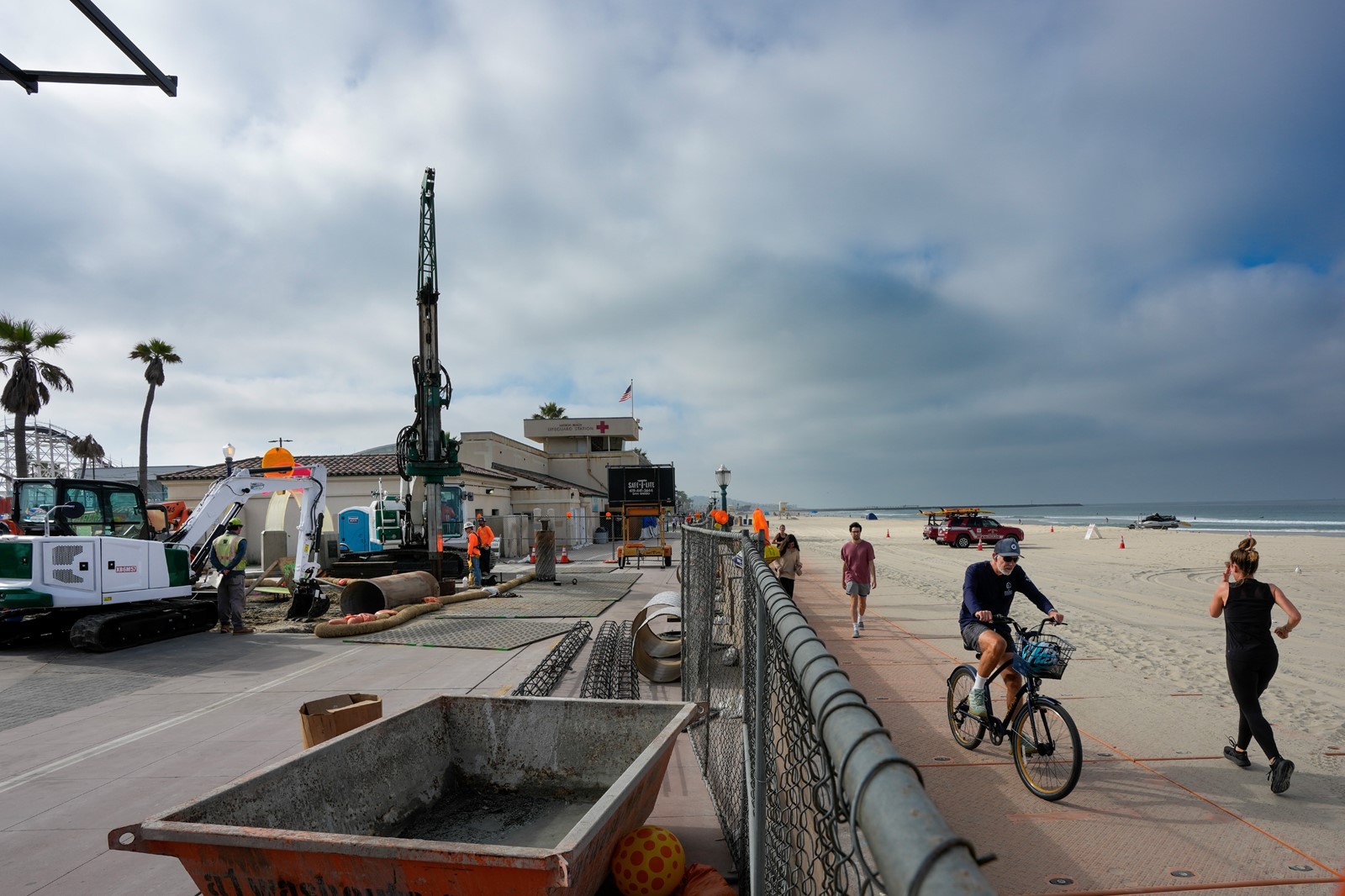 Bicyclists and joggers are diverted to a temporary walkway on the sand as construction continues on a temporary lifeguard tower just north of the existing lifeguard station in Mission Beach. Nelvin C. Cepeda / U-T